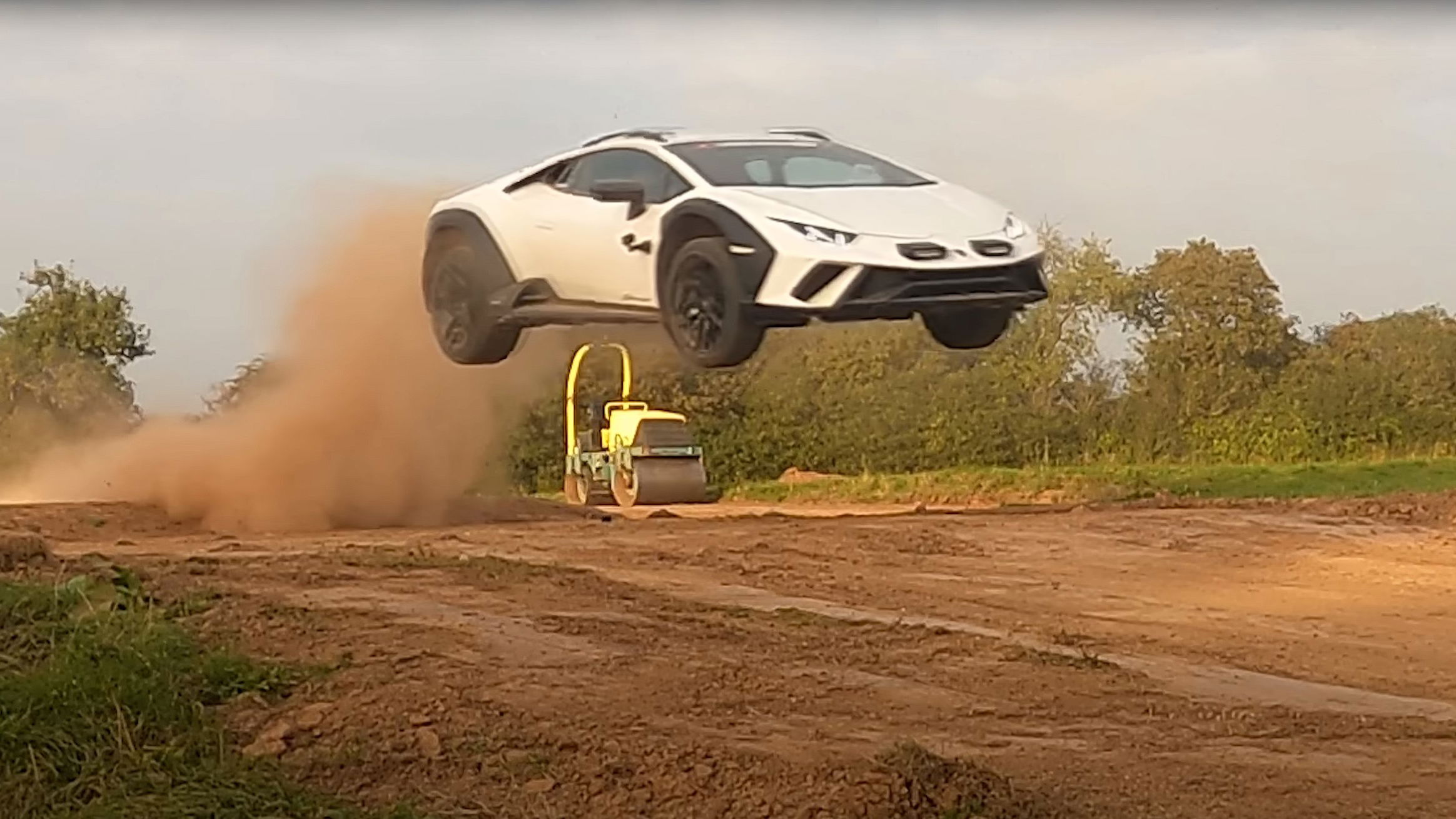 A white Lamborghini Huracan Sterrato jumping